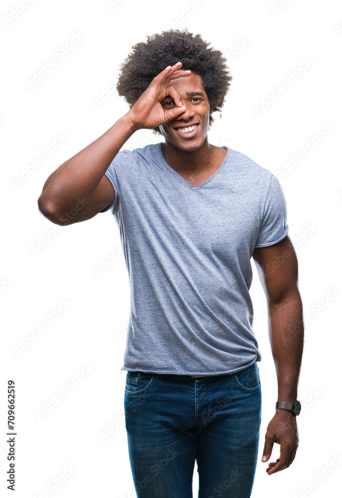 Afro american man over isolated background doing ok gesture with hand smiling, eye looking through fingers with happy face. Afro american man over isolated background doing ok gesture with hand smiling, eye looking through fingers with happy face.