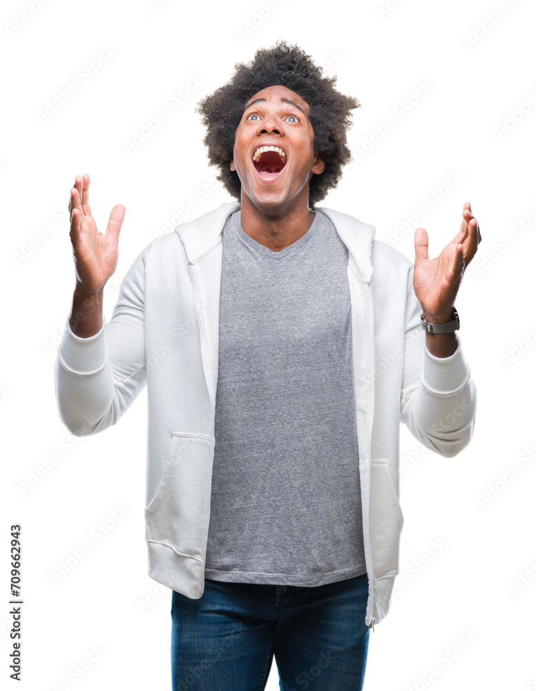 Afro american man wearing sweatshirt over isolated background celebrating crazy and amazed for success with arms raised and open eyes screaming excited. Winner concept Afro american man wearing sweatshirt over isolated background celebrating crazy and amazed for success with arms raised and open eyes screaming excited. Winner concept