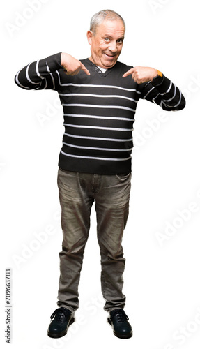 Handsome senior man wearing winter stripes sweater looking confident with smile on face, pointing oneself with fingers proud and happy.