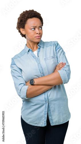 Young beautiful african american woman over isolated background smiling looking to the side with arms crossed convinced and confident