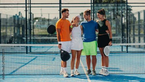 Winning moments: Athletes standing together on padel tennis court photo