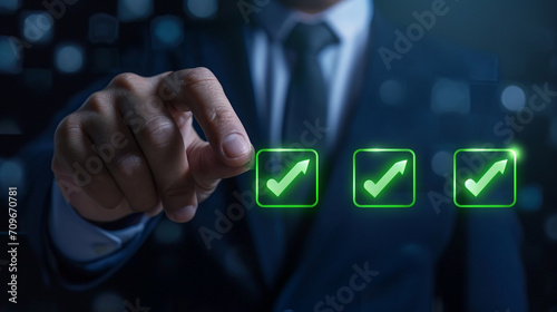 A business professional clicks the green checkmark to assess an industrial facility of a vendor or supplier, assigning maximum rating of five stars in accordance with the ISO documentation management. photo