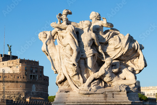 ROME, ITALY - SEPTEMBER 1, 2021: The sculpture The Fidelity to the Statute marble on the Ponte Vittorio Emanuele II bridge by Giuseppe Romagnoli (1910). photo