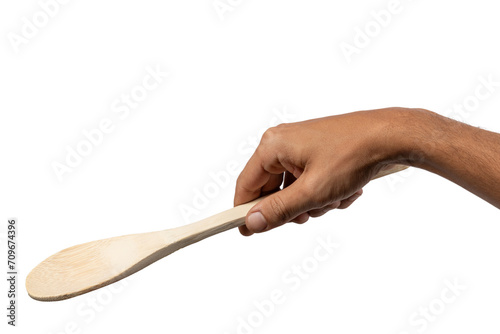 Male hand holding wooden spoon no background. photo