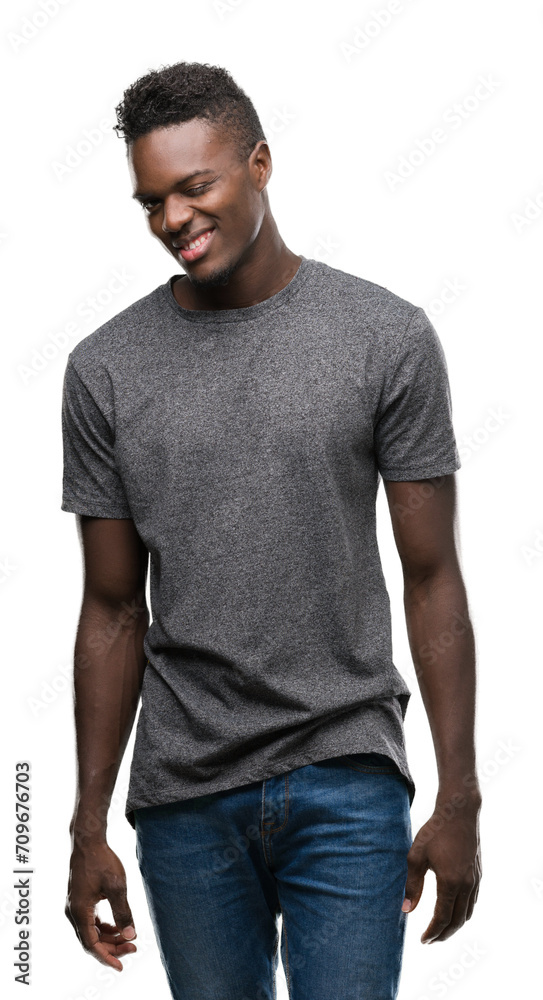 Young african american man wearing grey t-shirt winking looking at the camera with sexy expression, cheerful and happy face. Young african american man wearing grey t-shirt winking looking at the camera with sexy expression, cheerful and happy face.
