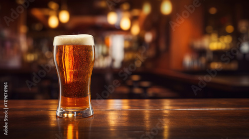 A refreshing glass of beer with frothy head on a wooden bar counter, in a warm, inviting pub atmosphere.