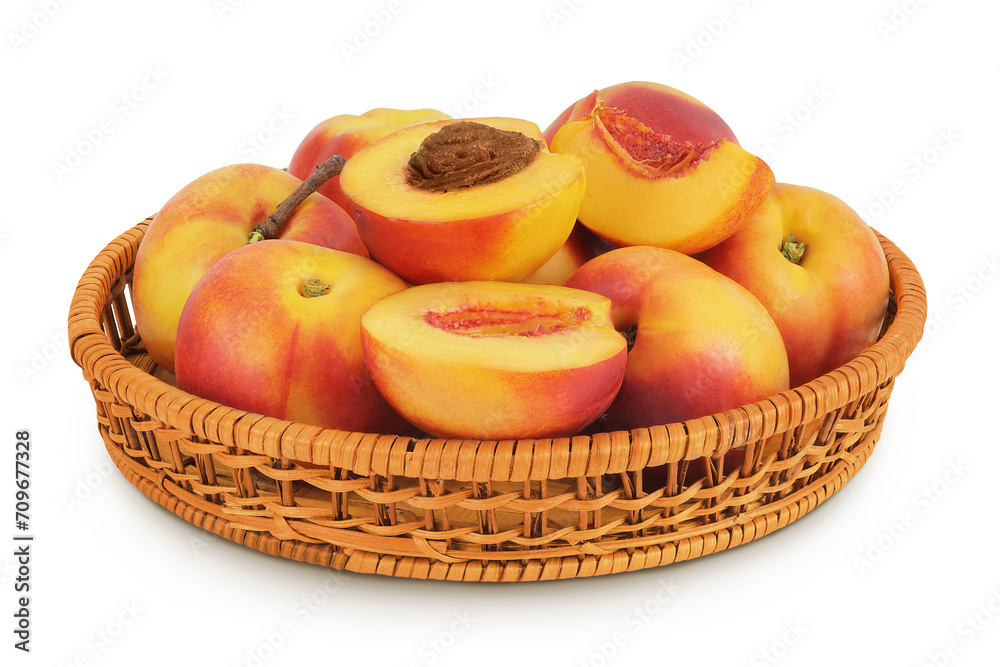 Ripe nectarine fruit with half in a wicker basket isolated on white background with full depth of field Ripe nectarine fruit with half in a wicker basket isolated on white background with full depth of field