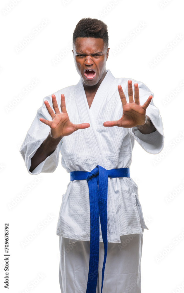 Young african american man over isolated background wearing kimono afraid and terrified with fear expression stop gesture with hands, shouting in shock. Panic concept.