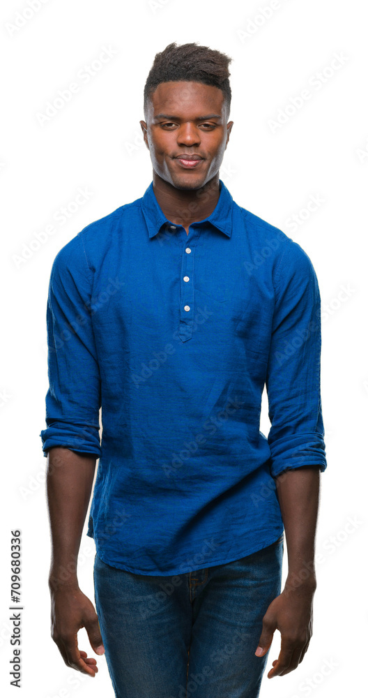 Young african american man over isolated background with serious expression on face. Simple and natural looking at the camera. Young african american man over isolated background with serious expression on face. Simple and natural looking at the camera.
