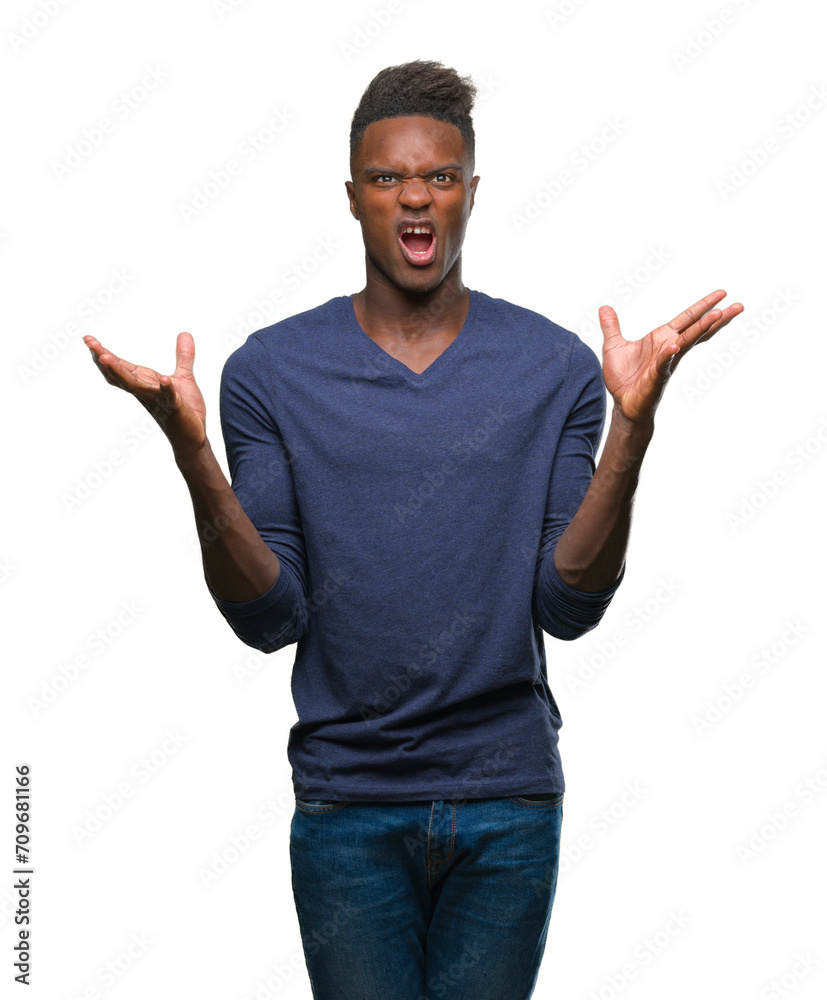 Young african american man over isolated background crazy and mad shouting and yelling with aggressive expression and arms raised. Frustration concept. Young african american man over isolated background crazy and mad shouting and yelling with aggressive expression and arms raised. Frustration concept.