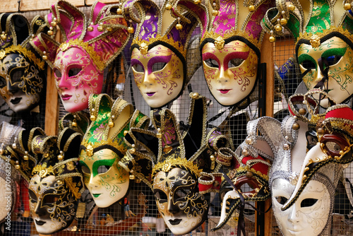 Traditional venetian masks on shelves in souvenirs shop in Venice, Italy. Beautiful carnival masks in variety of colours. Authentic and original Venetian full-face masks for Carnival. © Yuliya