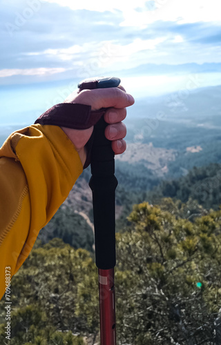 anonymous man with mountain pole hiking
