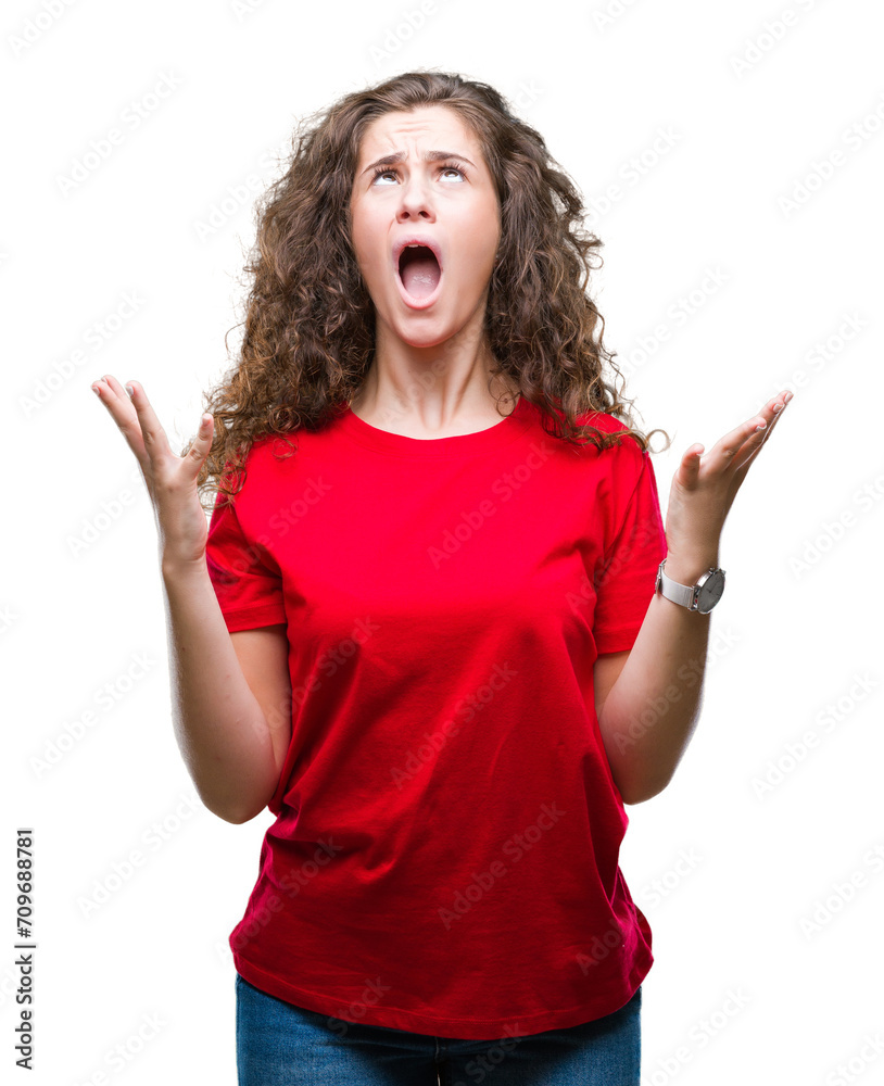 Beautiful brunette curly hair young girl wearing casual look over isolated background celebrating mad and crazy for success with arms raised and closed eyes screaming excited. Winner concept Beautiful brunette curly hair young girl wearing casual look over isolated background celebrating mad and crazy for success with arms raised and closed eyes screaming excited. Winner concept
