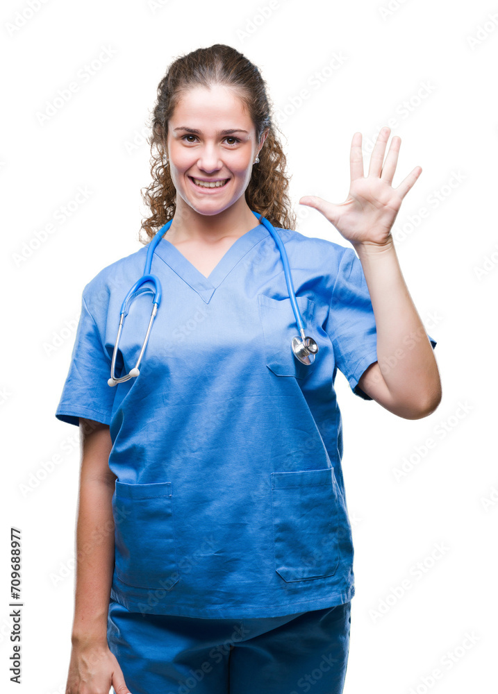 Young brunette doctor girl wearing nurse or surgeon uniform over isolated background showing and pointing up with fingers number five while smiling confident and happy. Young brunette doctor girl wearing nurse or surgeon uniform over isolated background showing and pointing up with fingers number five while smiling confident and happy.