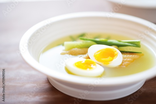close-up of asparagus soup with quail egg topping