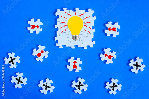 Business concept,collaboration,cooperation,teamwork, innovation,human resources,recruitment,team building with jigsaw puzzle pieces and light bulb symbol