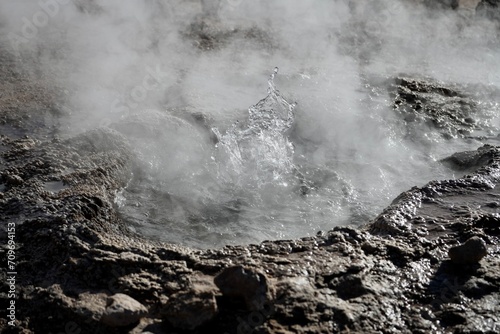 Hot water erupting from a geyser frozen in time. Geysers Del Tatio, Antofagasta, Chile.  photo