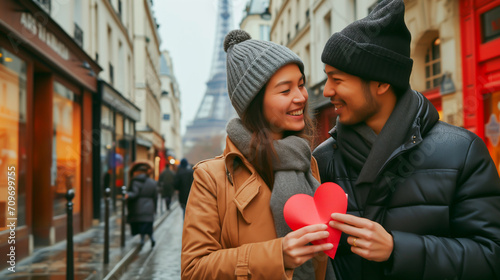Couple sharing a romantic moment with a heart in Paris, Valentine's Day theme. Shallow field of view.
