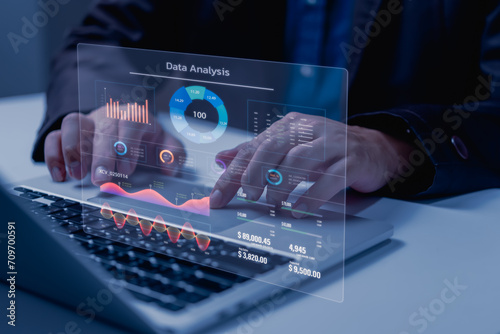 Business development and technology Data analyst for report marketing strategy planning. graph analysis and information on a futuristic virtual interface screen. photo