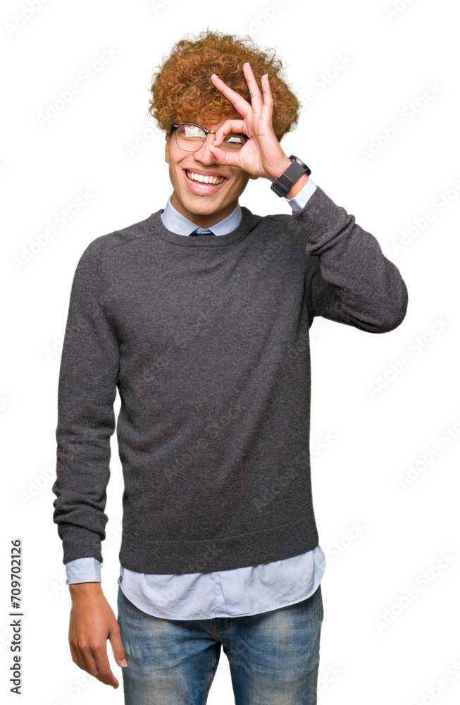 Young handsome business man with afro hair wearing glasses doing ok gesture with hand smiling, eye looking through fingers with happy face.