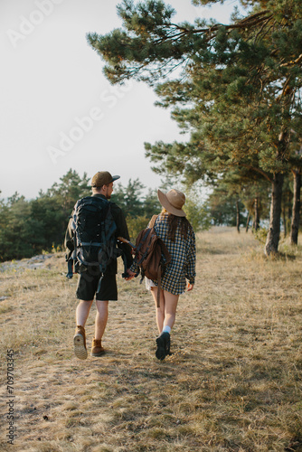 Young couple hiking on mountain. Back view.