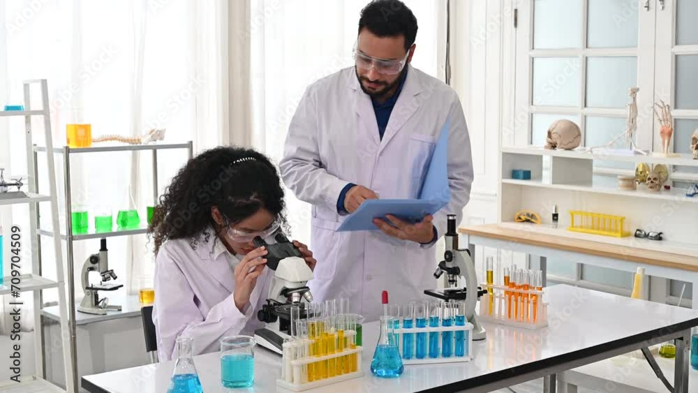 4K Scientist coworking together on research project with microscope 4K Scientist coworking together on research project with microscope