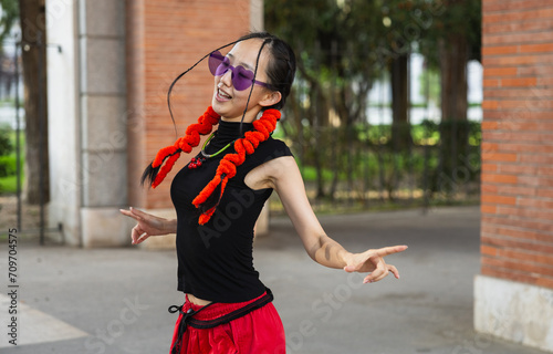 Scene of modern and urban asian woman dancing in the street