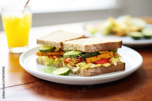 grilled tempeh sandwich with vegan cheese and pickles