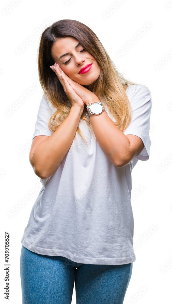 Young beautiful woman casual white t-shirt over isolated background sleeping tired dreaming and posing with hands together while smiling with closed eyes. Young beautiful woman casual white t-shirt over isolated background sleeping tired dreaming and posing with hands together while smiling with closed eyes.