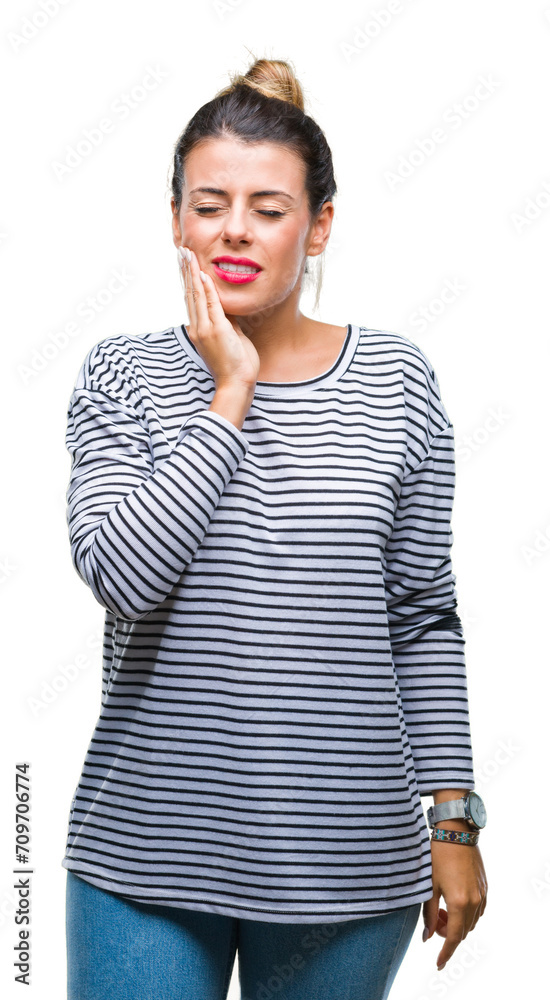 Young beautiful woman casual stripes sweater over isolated background touching mouth with hand with painful expression because of toothache or dental illness on teeth. Dentist concept. Young beautiful woman casual stripes sweater over isolated background touching mouth with hand with painful expression because of toothache or dental illness on teeth. Dentist concept.