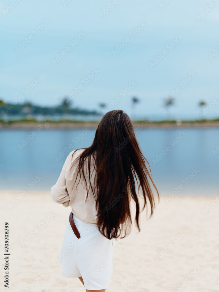 Tranquil Summer Seaside: Woman Enjoying Beauty and Serenity of the Ocean on a Sunny Beach, Embracing Nature's Escape Tranquil Summer Seaside: Woman Enjoying Beauty and Serenity of the Ocean on a Sunny Beach, Embracing Nature's Escape