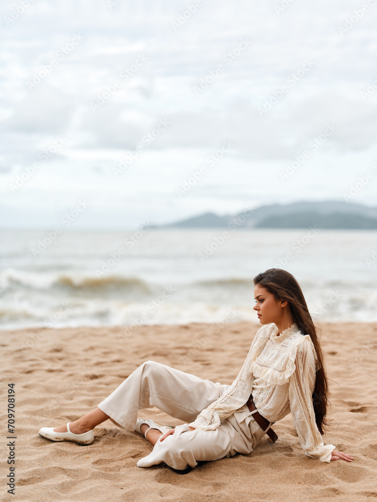 Beauty in Nature: A Stylish, Elegant Lady Sitting Alone on a Beach Chair, Enjoying the Sunset Overlooking the Blue Ocean Beauty in Nature: A Stylish, Elegant Lady Sitting Alone on a Beach Chair, Enjoying the Sunset Overlooking the Blue Ocean
