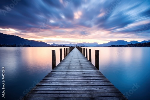 Long Exposure of a Wooden Pier Extending into Calm Lake at Twilight