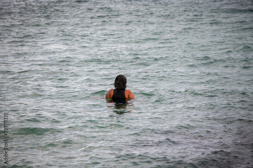 Rear view of woman seen swimming