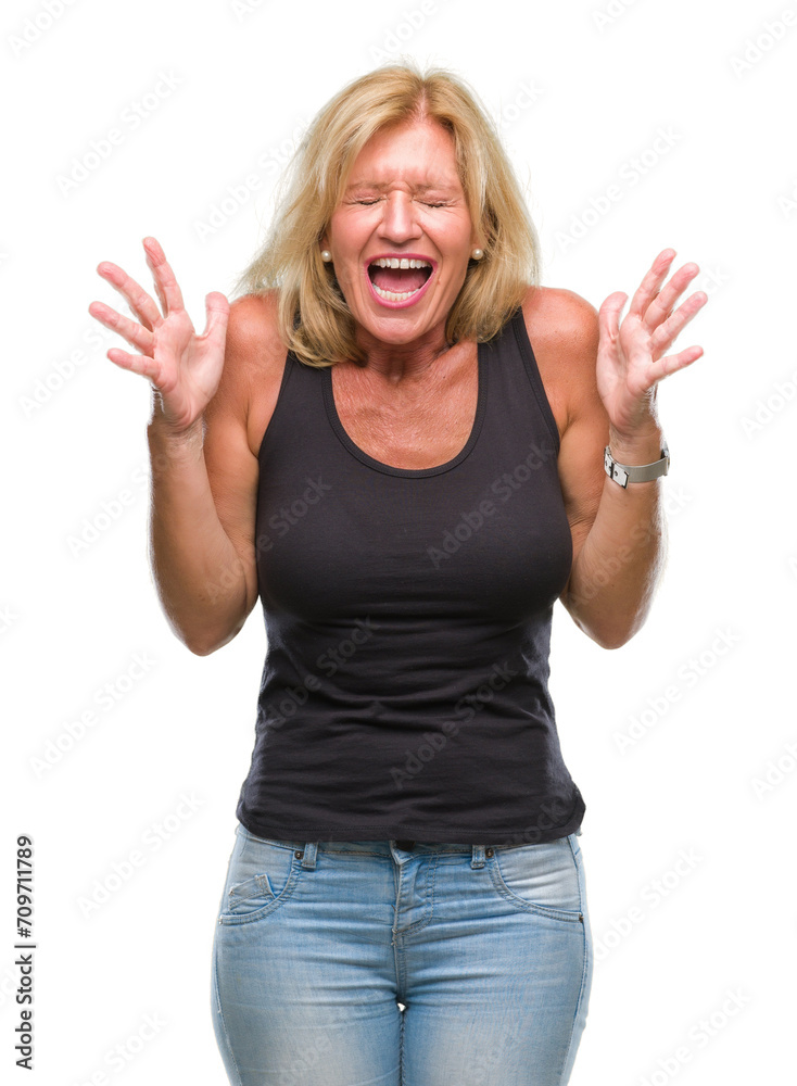 Middle age blonde woman over isolated background celebrating mad and crazy for success with arms raised and closed eyes screaming excited. Winner concept Middle age blonde woman over isolated background celebrating mad and crazy for success with arms raised and closed eyes screaming excited. Winner concept
