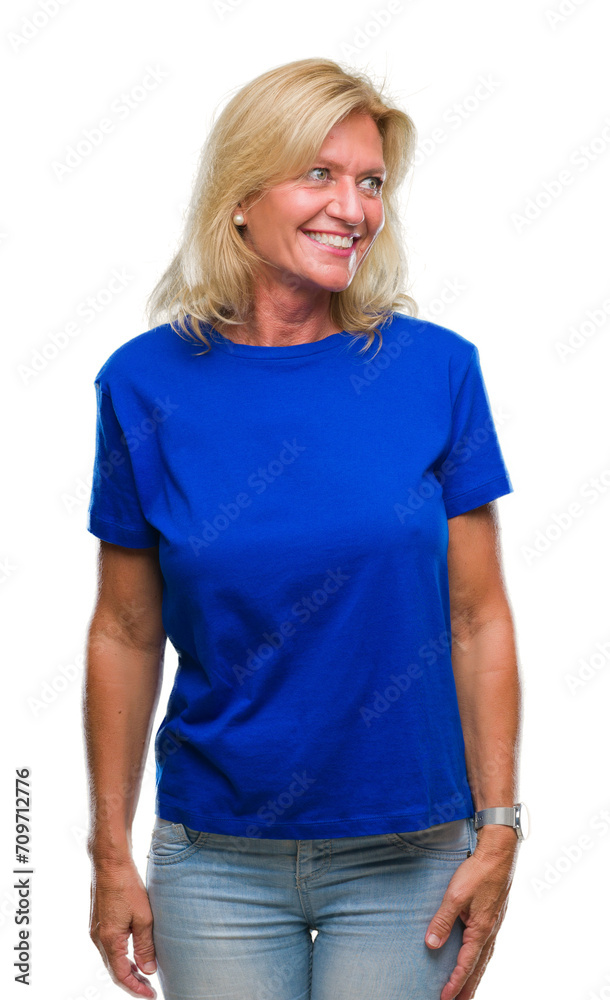 Fototapeta premium Middle age blonde woman over isolated background looking away to side with smile on face, natural expression. Laughing confident.