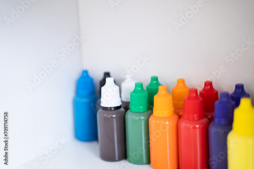 Bottles of art paints of various colors were lined up in large numbers