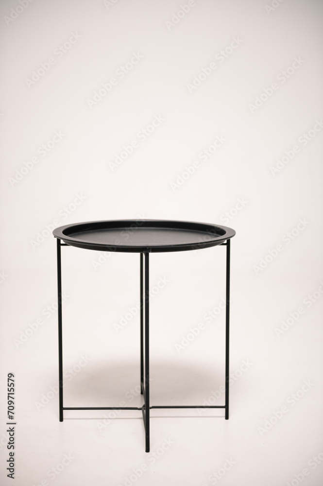 Stylish coffee table in loft style on a white background. Metal black round coffee table isolated on a white background. Stylish coffee table in loft style on a white background. Metal black round coffee table isolated on a white background.