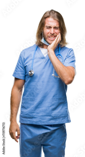 Young handsome doctor man with long hair over isolated background touching mouth with hand with painful expression because of toothache or dental illness on teeth. Dentist concept.