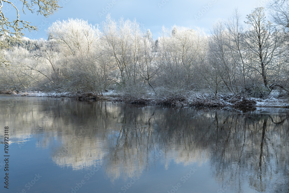 Reflections of snow covered trees in the River Teviot, Scottish Borders, United Kingdom Reflections of snow covered trees in the River Teviot, Scottish Borders, United Kingdom