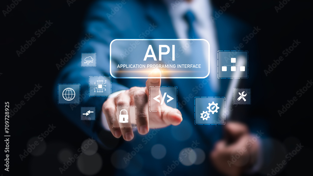 API Application Programming Interface concept. Businessman touch virtual screen of API icon Software development tool. API Application Programming Interface concept. Businessman touch virtual screen of API icon Software development tool.