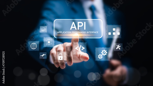 API Application Programming Interface concept. Businessman touch virtual screen of API icon Software development tool.