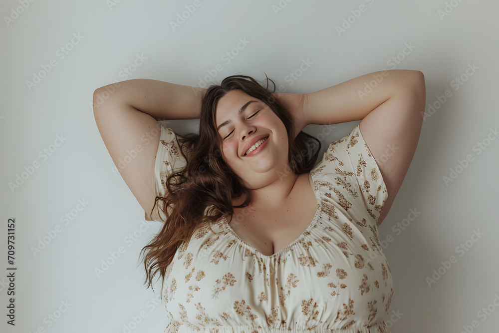 Happy plus size  smiling beautiful woman with arms raised isolated
