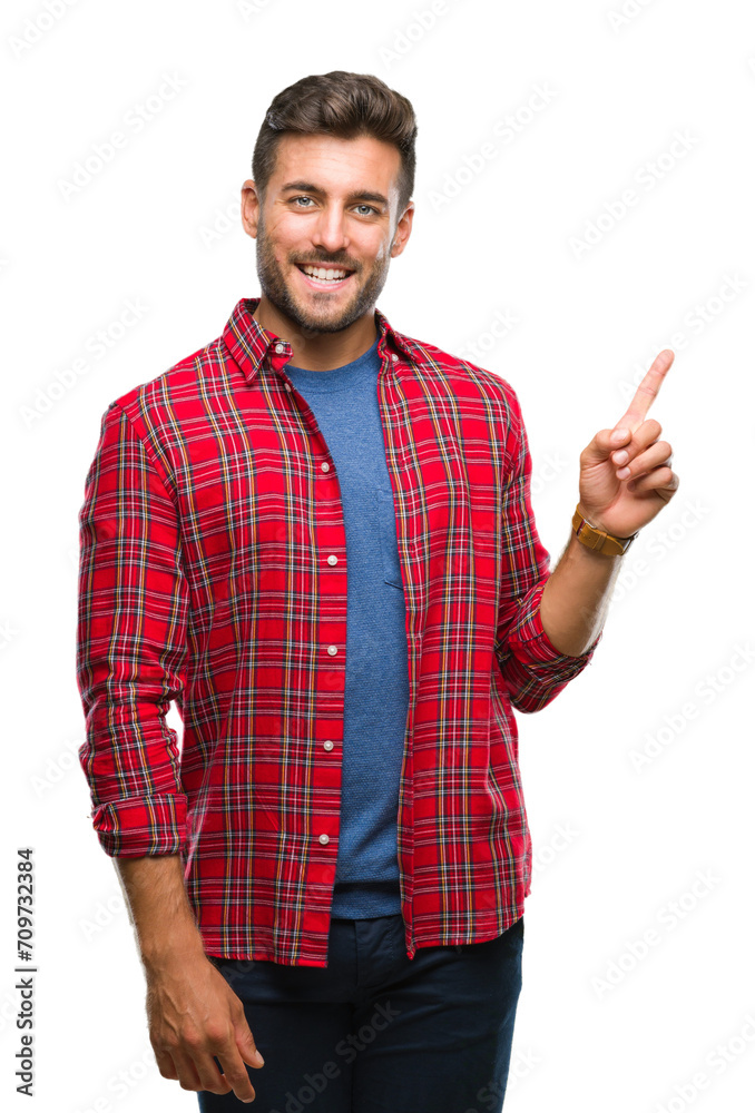 Young handsome man over isolated background with a big smile on face, pointing with hand and finger to the side looking at the camera. Young handsome man over isolated background with a big smile on face, pointing with hand and finger to the side looking at the camera.