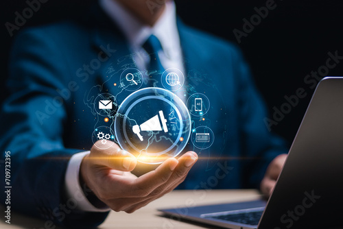 Online advertisement concept, businessman use laptop with virtual advertisement icon for ad on website or social media, online ads and digital marketing. photo