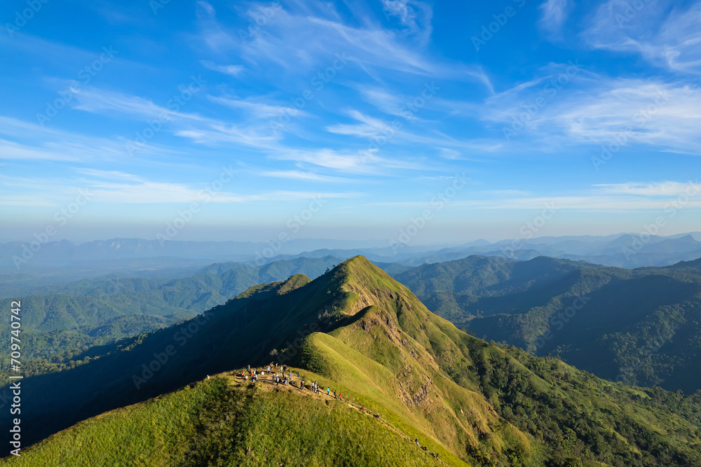 Naklejka premium Green yellow mountains and beautiful sky clouds under the blue sky.