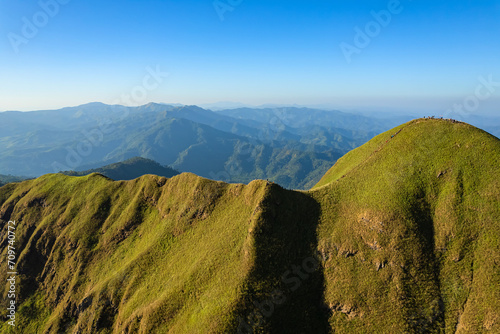 Green yellow mountains and beautiful sky clouds under the blue sky. photo