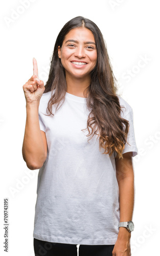 Young beautiful arab woman over isolated background showing and pointing up with finger number one while smiling confident and happy.
