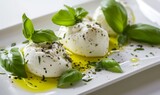 Mozzarella cheese topped with fresh basil and ground pepper.