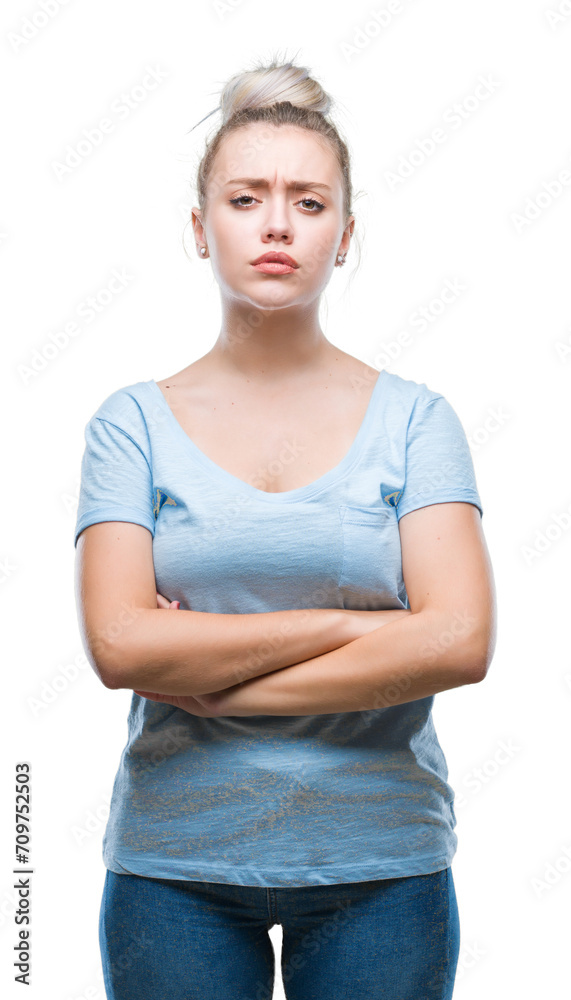 Young blonde woman over isolated background skeptic and nervous, disapproving expression on face with crossed arms. Negative person. Young blonde woman over isolated background skeptic and nervous, disapproving expression on face with crossed arms. Negative person.